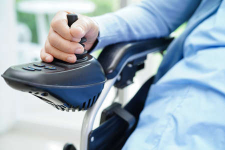 Asian elderly woman disability patient walk with walker in nursing hospital, medical concept.