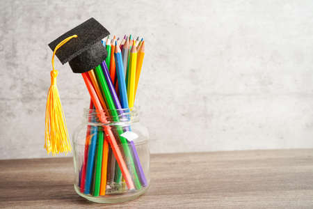 Colorful pencils in glass jar with copy space, learning university education concept.