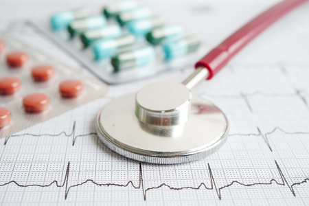 Stethoscope on electrocardiogram (ECG) with drug, heart wave, heart attack, cardiogram report.の写真素材