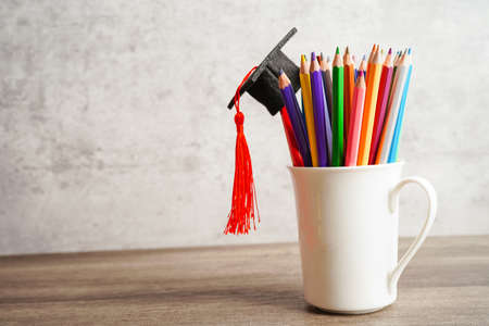 Colorful pencils in glass jar with copy space, learning university education concept.の写真素材