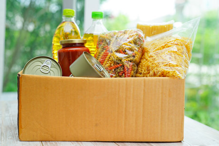 Foodstuffs in donation box for volunteer.の写真素材