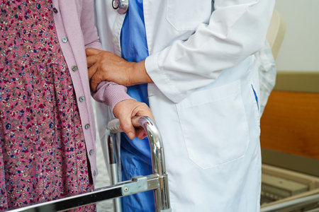 Doctor help Asian elderly woman disability patient in nursing hospital, medical concept.の写真素材