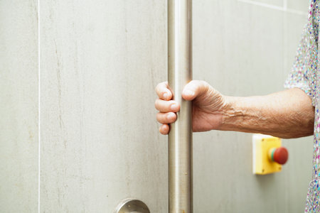 Asian elderly old woman patient use support rail on ramp, handrail safety grab bar, security in...