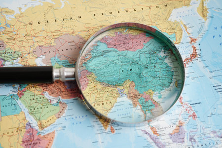 Bangkok, Thailand - May 15, 2022 Magnifying glass on world map.のeditorial素材