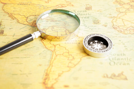 Bangkok, Thailand - December 15, 2021 Magnifying glass on ancient vintage world map.のeditorial素材