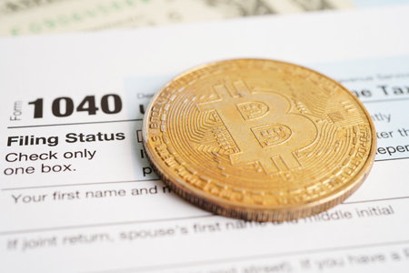 Tax form 1040 U.S. Individual Income Tax Return and bitcoin, business finance, Digital currency, Virtual cryptocurrency concept.の写真素材
