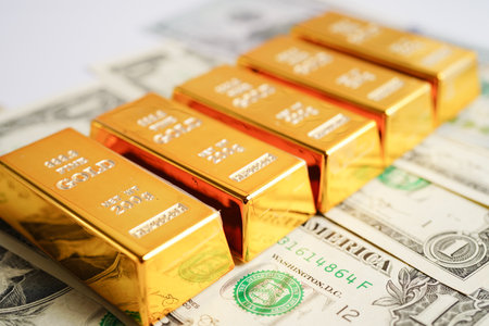 Gold bars on US dollar banknote money, finance trading investment business currency concept.の写真素材