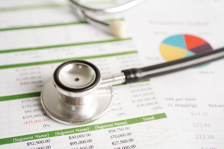 Stethoscope and US dollar banknotes on chart or graph paper, Financial, account, statistics and business data  medical health concept.の写真素材