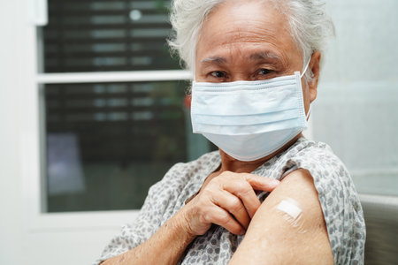 Asian elder senior woman getting vaccine for protect corona virus.の写真素材