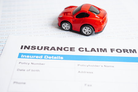 Stethoscope on Insurance claim accident car form, Car loan, insurance and leasing time concepts.の写真素材
