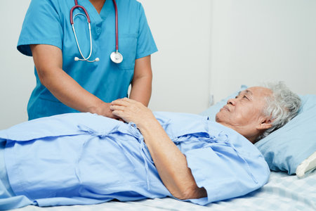 Doctor holding hands Asian elderly woman patient, help and care in hospital.の写真素材