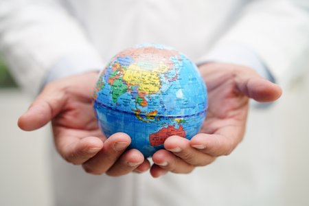 Asian man doctor holding globeの写真素材