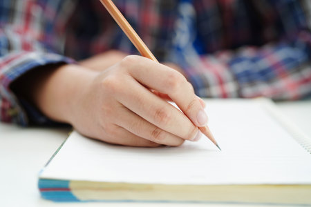 Asian teenage student write homework, study lesson for exam online learning education.