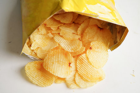 Potato chips in open bag, delicious BBQ seasoning spicy for crips, thin slice deep fried snack fast...
