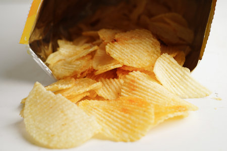 Potato chips in open bag, delicious BBQ seasoning spicy for crips, thin slice deep fried snack fast...