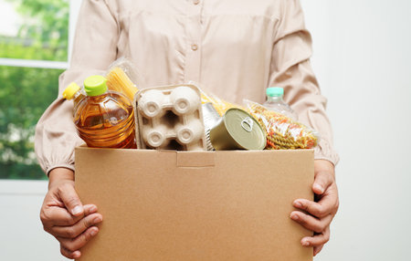 Foodstuffs in donation box for volunteer to help people.の写真素材