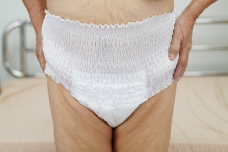 Asian elder senior woman patient wearing adult incontinence diaper pad in hospital.の写真素材