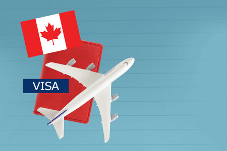 Canada Visa and passport with airplane and flag on white background with copy space.の写真素材