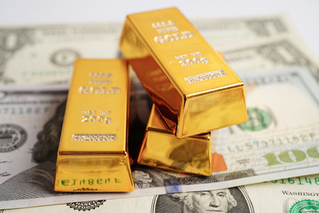Gold bars on US dollar banknote money, finance trading investment business currency concept.の写真素材
