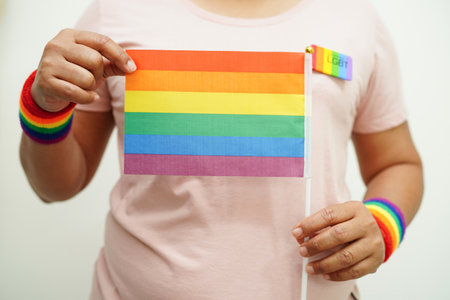 Asian woman with rainbow flag, LGBT symbol rights and gender equality, LGBT Pride Month in June.の写真素材