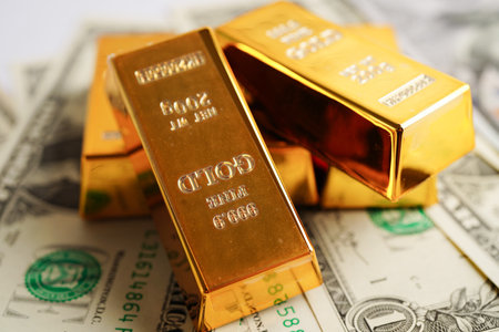 Gold bars on US dollar banknote money, finance trading investment business currency concept.の写真素材