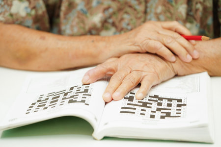 elderly woman playing sudoku puzzle game for treatment dementia prevention and Alzheimer disease.の写真素材