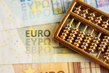 Gold abacus on banknote money, finance trading investment business currency concept.の写真素材