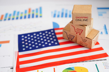 Online shopping, Shopping cart box on USA America flag, import export, finance commerce.