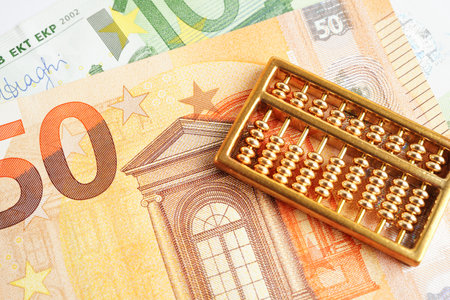 Gold abacus on banknote money, finance trading investment business currency concept.の写真素材