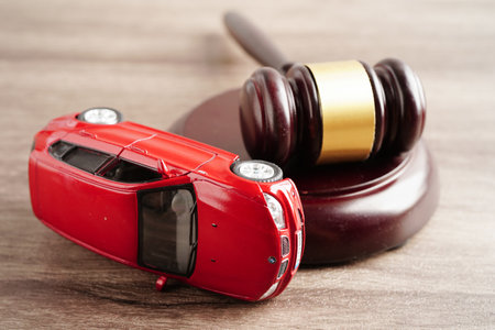 Bangkok, Thailand March 15, 2023 Car accident lawsuit and insurance, Judge hammer with car model.の写真素材