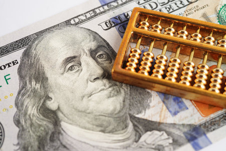 Gold abacus on banknote money, finance trading investment business currency concept.の写真素材