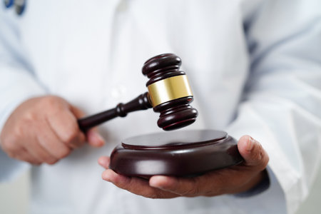 Asian doctor holding court hammer for and crime law justice, forensic medicine.の写真素材