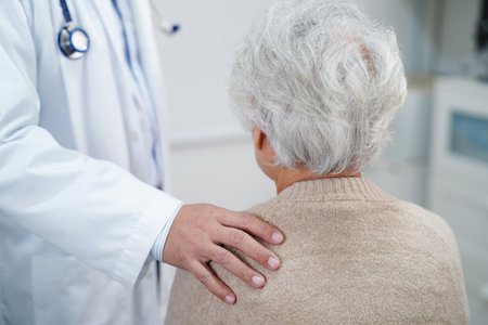 Asian doctor touching patient to support, consolation encourage and help support health care medical.の写真素材