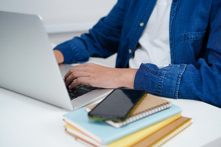 Asian teenage student write homework with laptop computer, learning university education concept.の写真素材