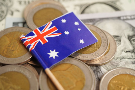New Zealand flag on coins background, finance and accounting, banking concept.の写真素材