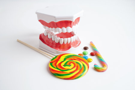 Tooth decay with sweet sugar candy, bad food for dental health care.の写真素材