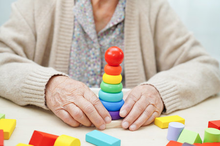 Asian elderly woman playing puzzles game for treatment dementia prevention and Alzheimer disease.の写真素材
