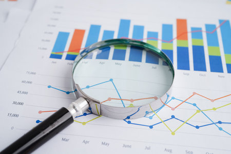 Magnifying glass on charts graphs paper. Financial development, Banking Account, Statistics, Investment Analytic research data economy.の写真素材