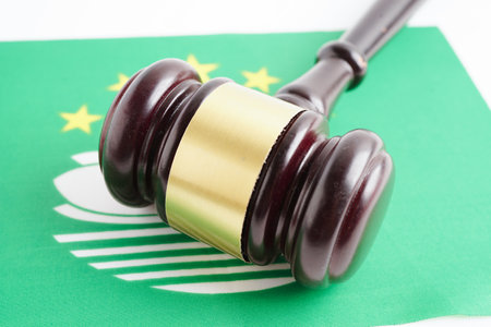 Macau, Legal, justice and agreement, wooden court gavel on flag.の写真素材