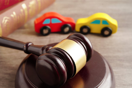 Car accident lawsuit and insurance, Judge hammer with car model.の写真素材