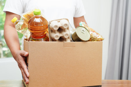 Foodstuffs in donation box for volunteer to help people.