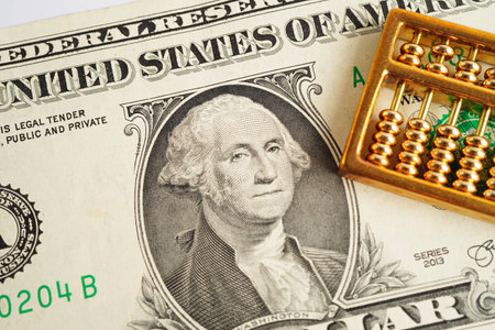 Gold abacus on banknote money, finance trading investment business currency concept.の写真素材