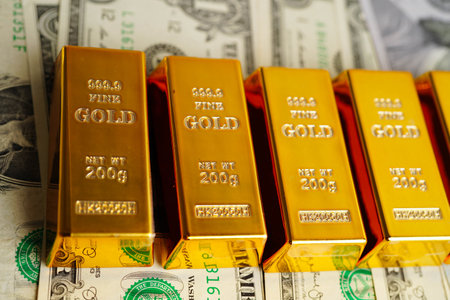 Gold bars with US dollar and Euro banknote money, finance trading investment business currency.の写真素材