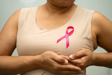Asian woman with pink ribbon for October world breast cancer day.の写真素材