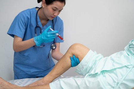 Asian doctor inject Hyaluronic acid platelet rich plasma into knee of senior woman.の写真素材