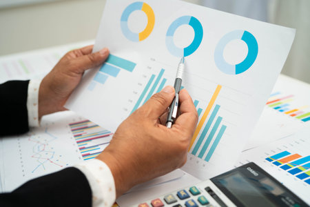 Asian business woman working with financial graph.