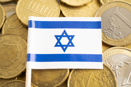 Israel flag on coins background, finance and accounting, banking concept.の写真素材