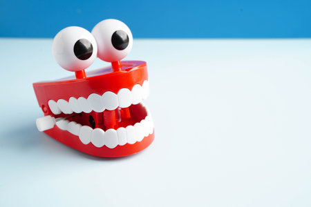 Funny red teeth with eye toy denture model for dental health care.