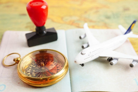 Passport with airplane and flag on white background with copy space.の写真素材