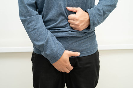 Hernia, Asian man stomach ache, abdominal pain and urology problem health.の写真素材